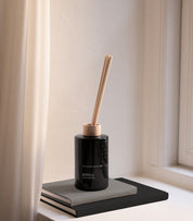 KOTO leathery vanilla scent diffuser of organic vegan room fragrance with 8 sticks in black coloured glass jars for the best in Nordic home style from Skandinavisk