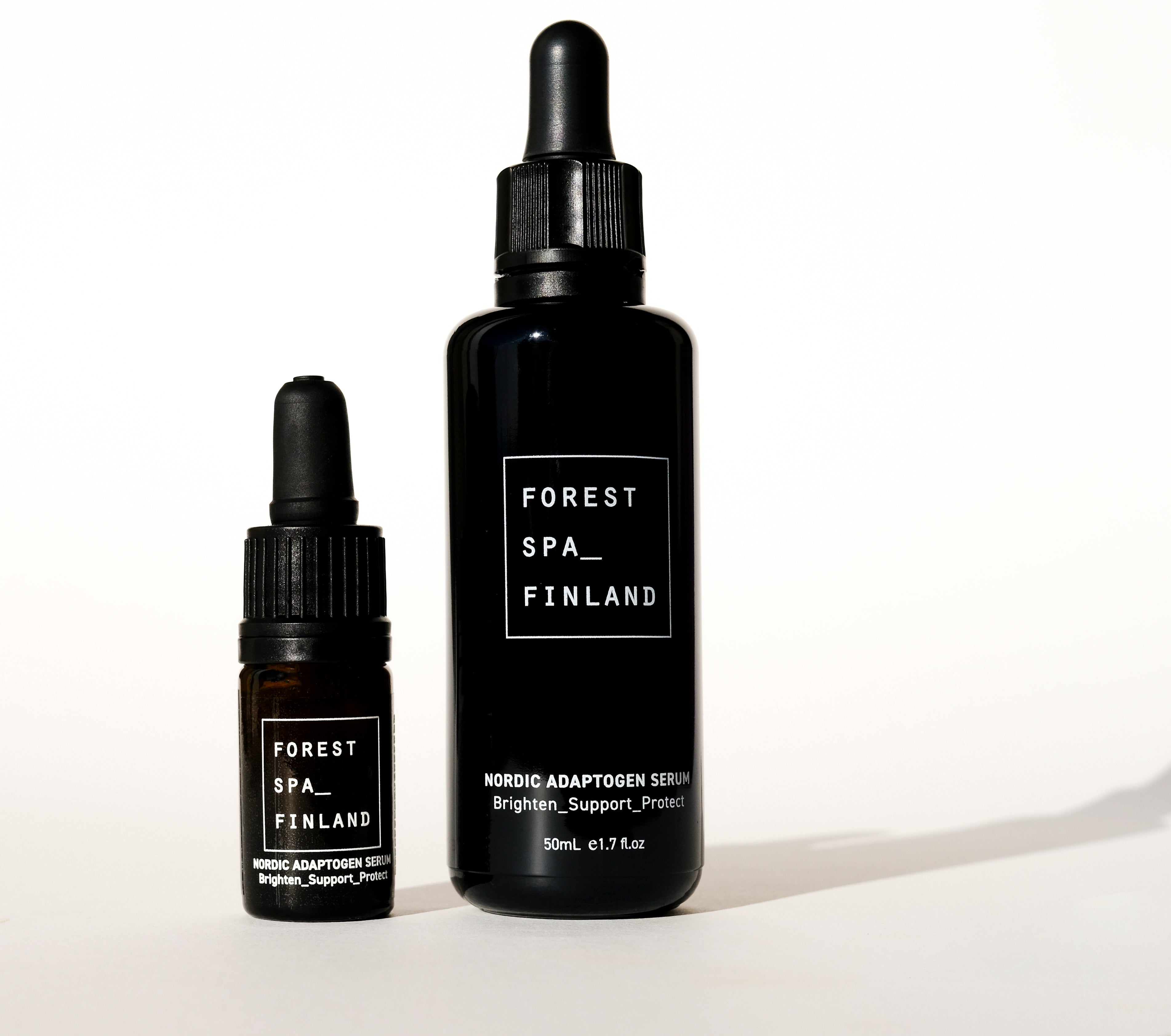 Black glass dropper bottle in 2 sizes, full of active Nordic Adaptogens for the skin to brighten, support and protect direct from Forest Spa Finland