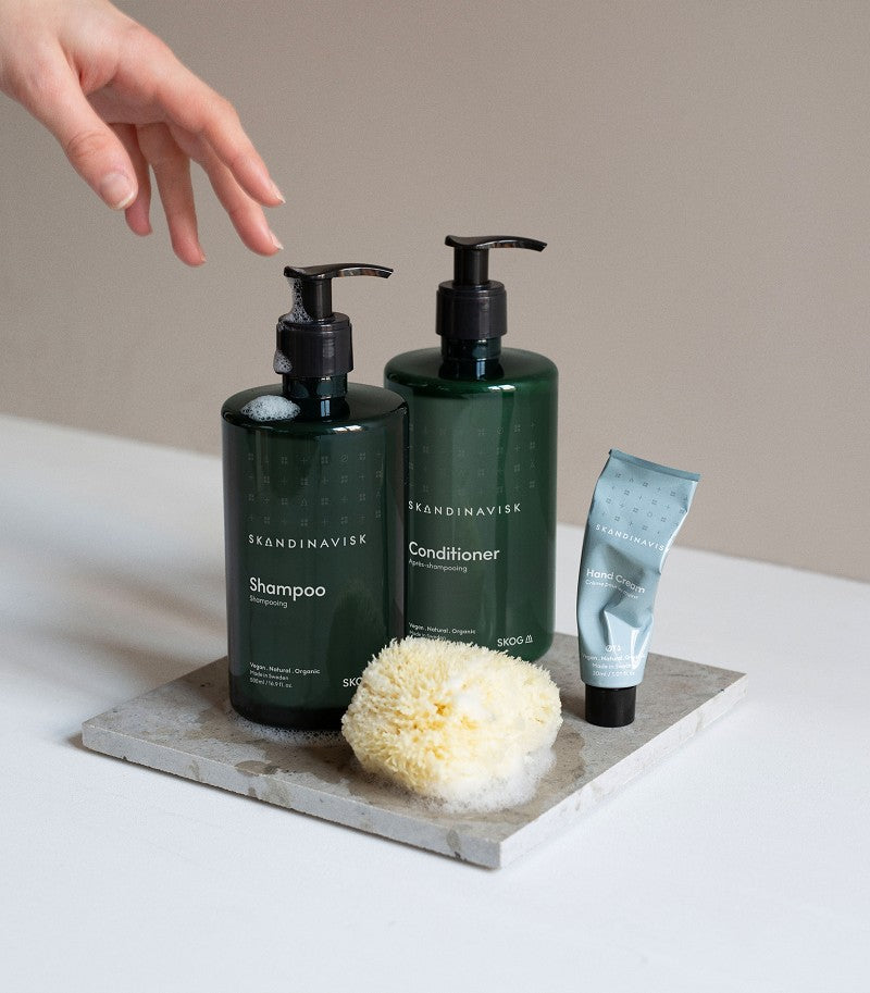 A beautiful Nordic bathroom set of sustainable, organic & vegan shampoo & conditioner SKOG, from Skandinavisk in refillable bioplastic pump bottle 500ml