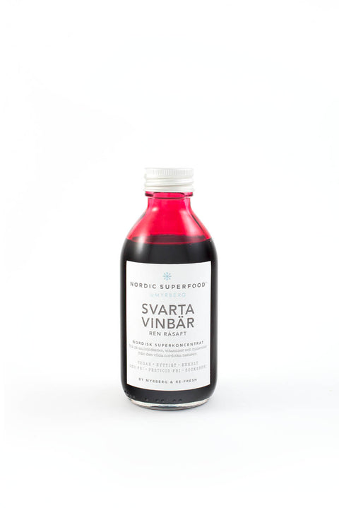 Glass bottle of pure, concentrated raw pressed blueberry health shot from Nordic Superfoods