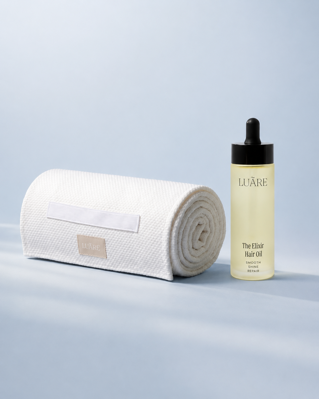White hair hug towel and golden hair elixir treatment oil from Luare