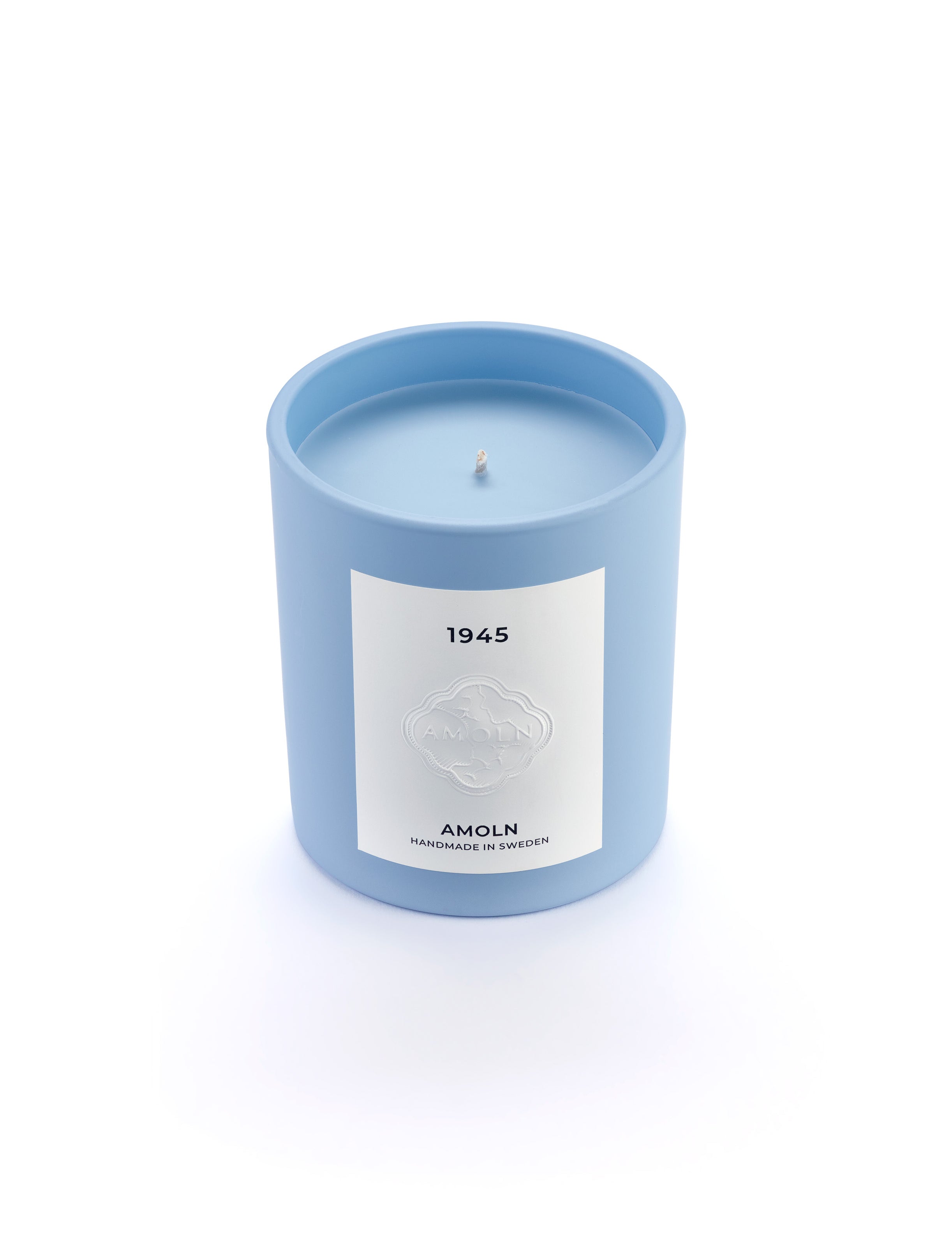 Signature blue candle in the same sky blue ceramic jar, inspired by Scandinavian skies, in the scent 1945  - a blend of citrus, florals and woods from Amoln, makers of Sweden's royal candles.