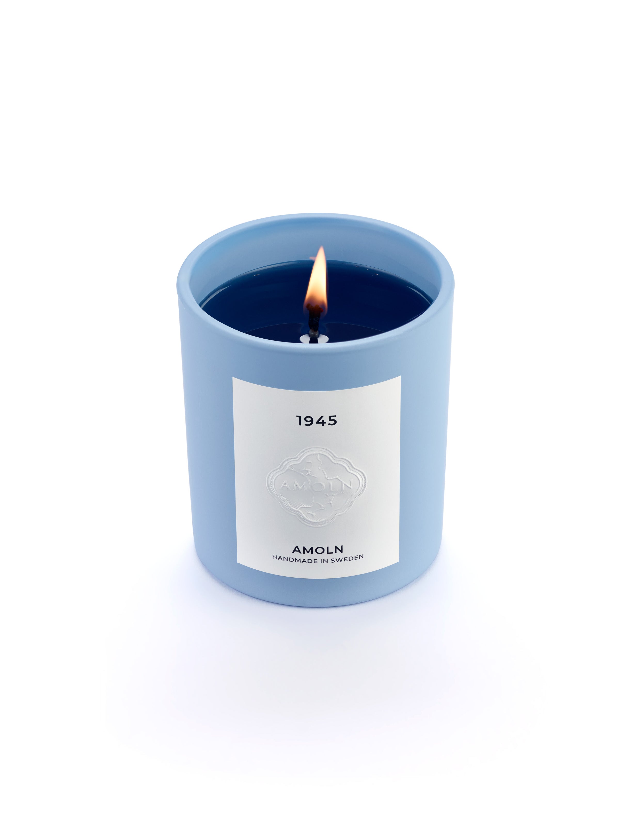 Signature blue candle in the same sky blue ceramic jar, inspired by Scandinavian skies, in the scent 1945 - a blend of citrus, florals and woods from Amoln, makers of Sweden's royal candles.