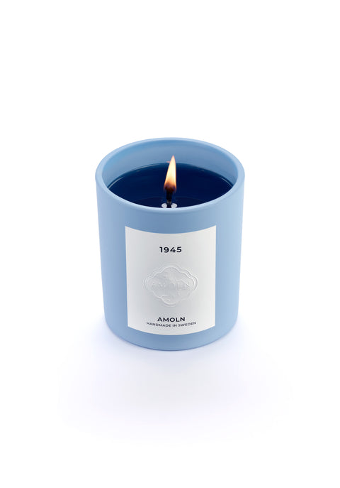 Signature blue candle in the same sky blue ceramic jar, inspired by Scandinavian skies, in the scent 1945 - a blend of citrus, florals and woods from Amoln, makers of Sweden's royal candles.