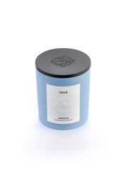 Signature blue candle in the same sky blue ceramic jar, inspired by Scandinavian skies, in the scent 1945 - a blend of citrus, florals and woods from Amoln, makers of Sweden's royal candles.