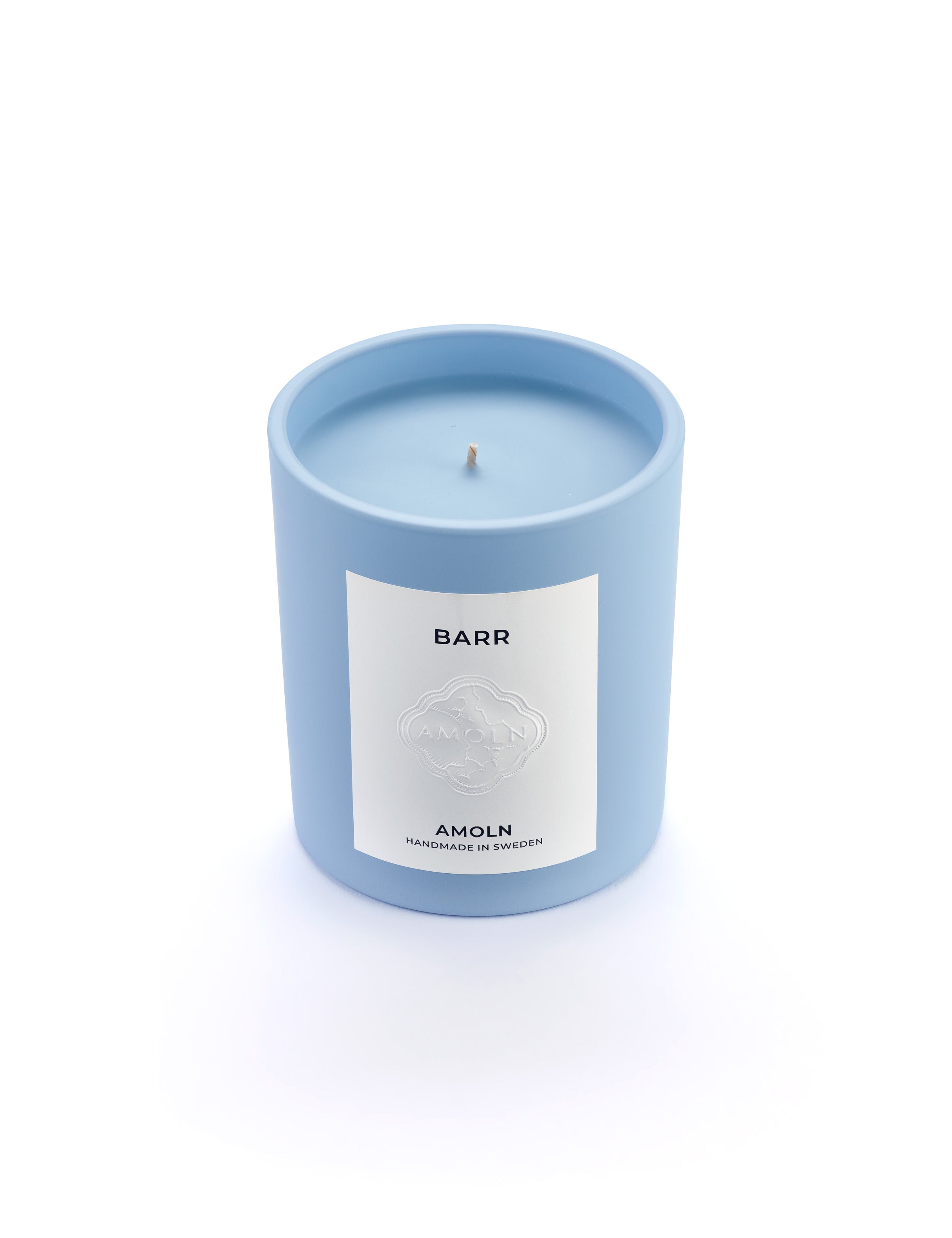 Signature blue candle in the same sky blue ceramic jar, inspired by Scandinavian skies, in the scent BARR - a blend of pine, cinnamon & resin from Amoln, makers of Sweden's royal candles.