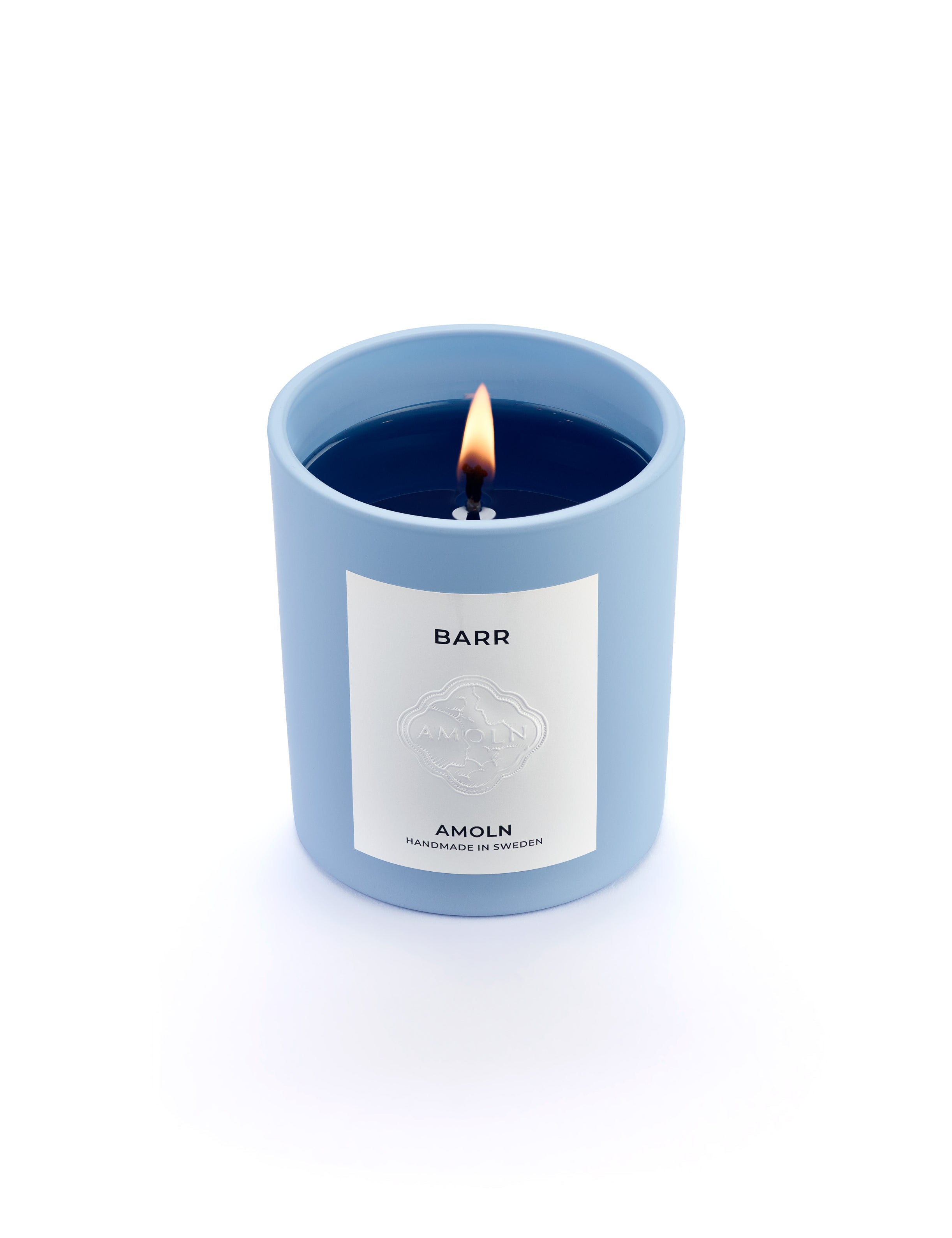 Signature blue candle in the same sky blue ceramic jar, inspired by Scandinavian skies, in the scent BARR - a blend of pine, cinnamon & resin from Amoln, makers of Sweden's royal candles.