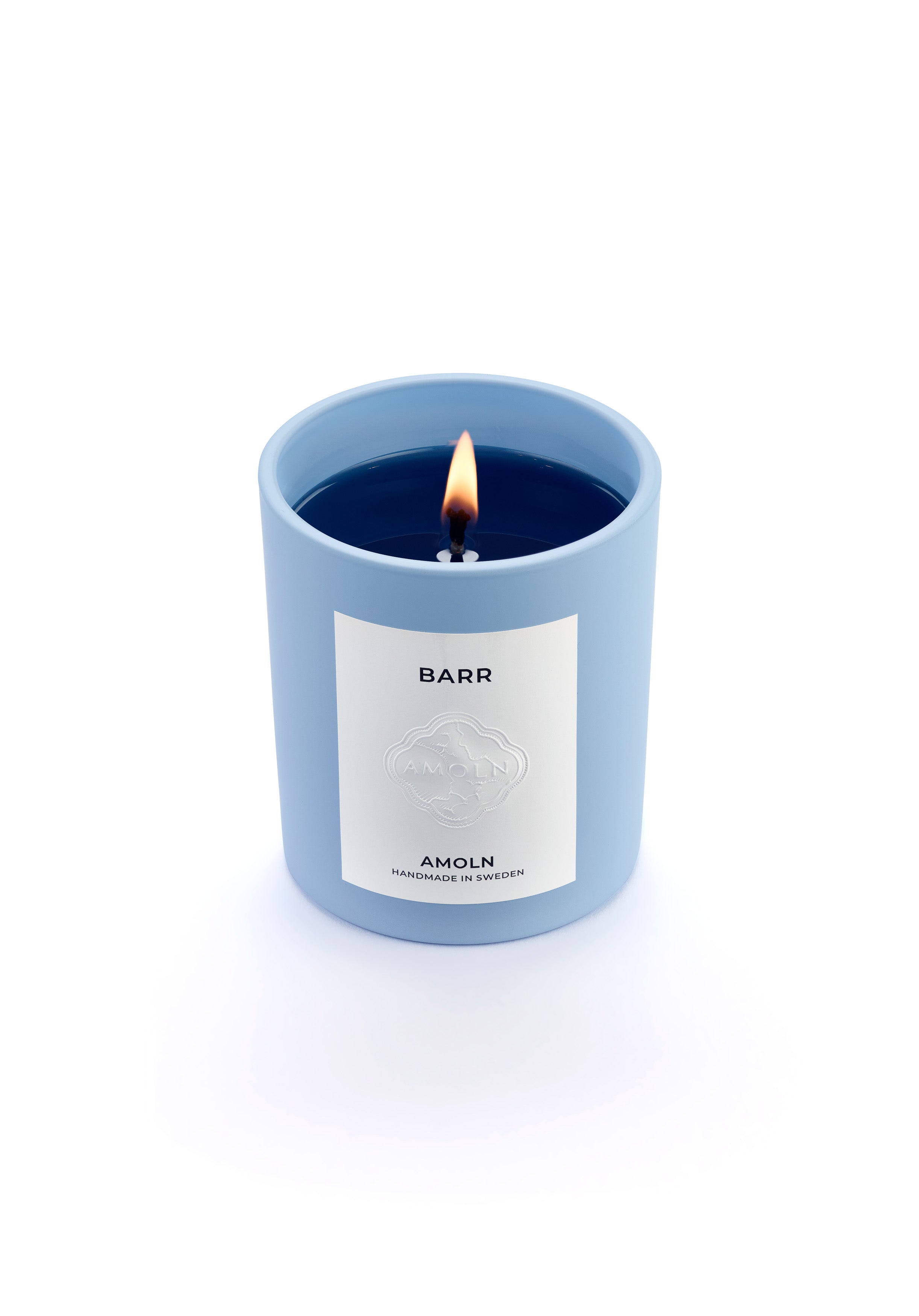 Signature blue candle in the same sky blue ceramic jar, inspired by Scandinavian skies, in the scent BARR - a blend of pine, cinnamon & resin from Amoln, makers of Sweden's royal candles.