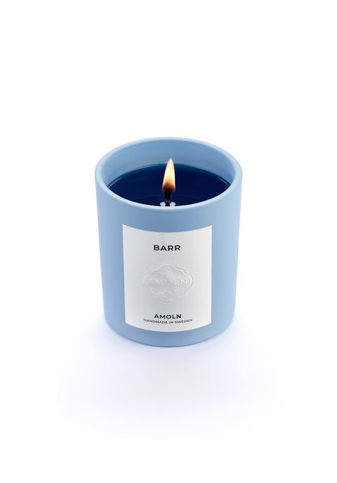 Signature blue candle in the same sky blue ceramic jar, inspired by Scandinavian skies, in the scent BARR - a blend of pine, cinnamon & resin from Amoln, makers of Sweden's royal candles.