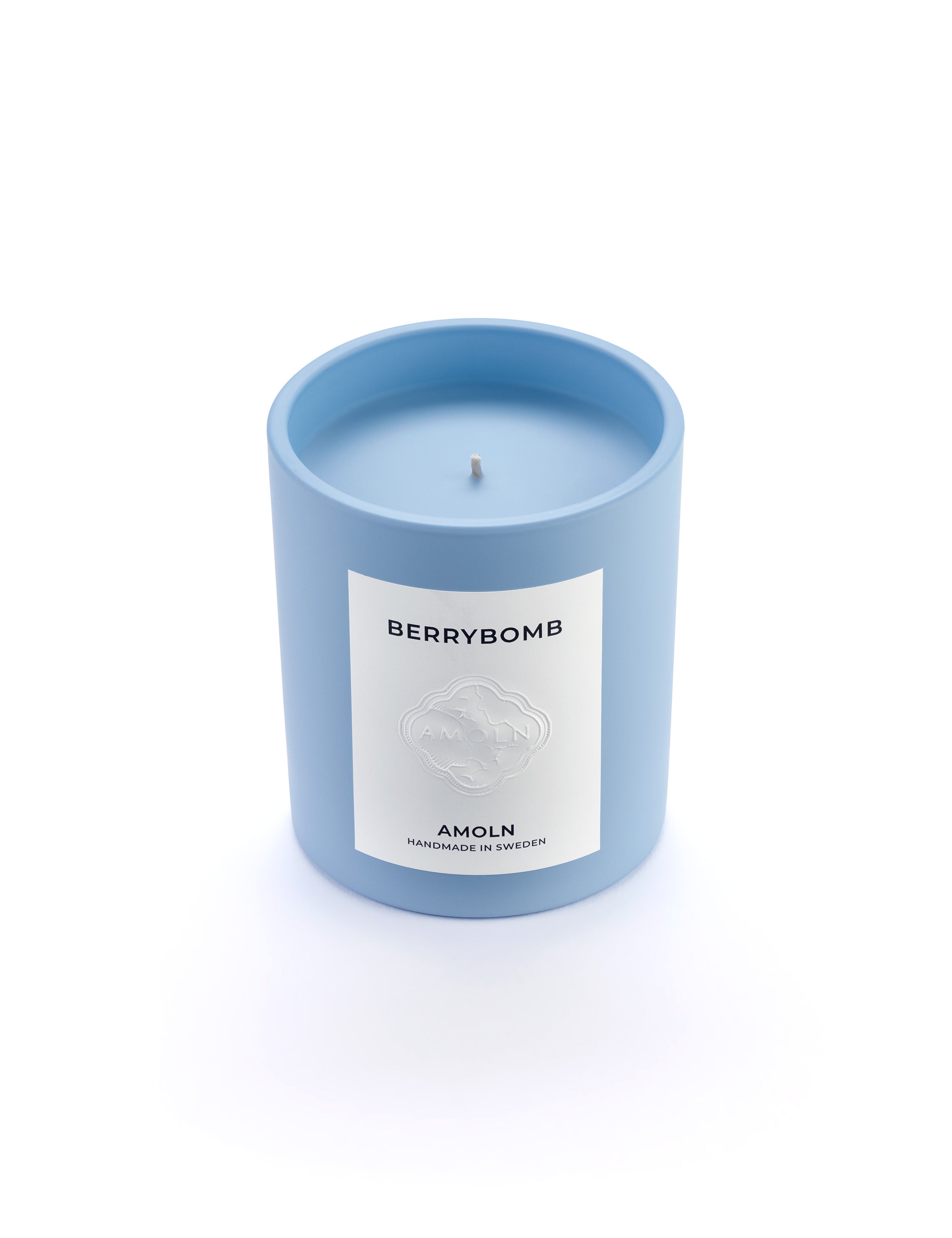 Signature blue candle in the same sky blue ceramic jar, inspired by Scandinavian skies, in the scent Berrybomb - a blend of fruits, florals, leather & musk from Amoln, makers of Sweden's royal candles.