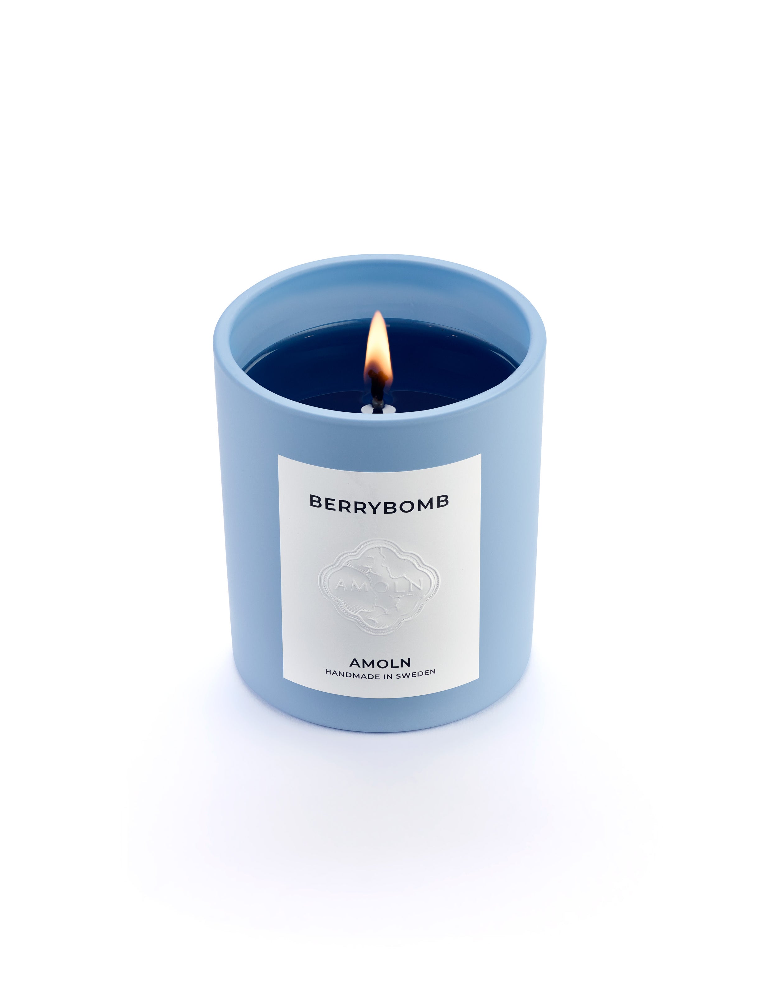 Signature blue candle in the same sky blue ceramic jar, inspired by Scandinavian skies, in the scent Berrybomb - a blend of fruits, florals, leather & musk from Amoln, makers of Sweden's royal candles.