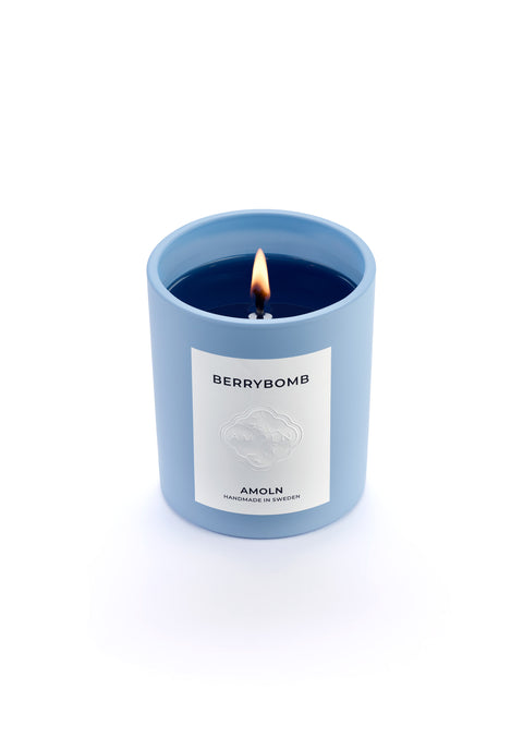 Signature blue candle in the same sky blue ceramic jar, inspired by Scandinavian skies, in the scent Berrybomb - a blend of fruits, florals, leather & musk from Amoln, makers of Sweden's royal candles.
