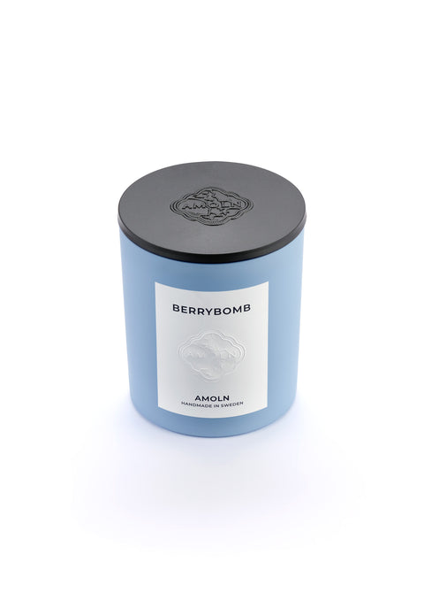 Signature blue candle in the same sky blue ceramic jar, inspired by Scandinavian skies, in the scent Berrybomb- a blend of fruits, florals, leather & musk from Amoln, makers of Sweden's royal candles.