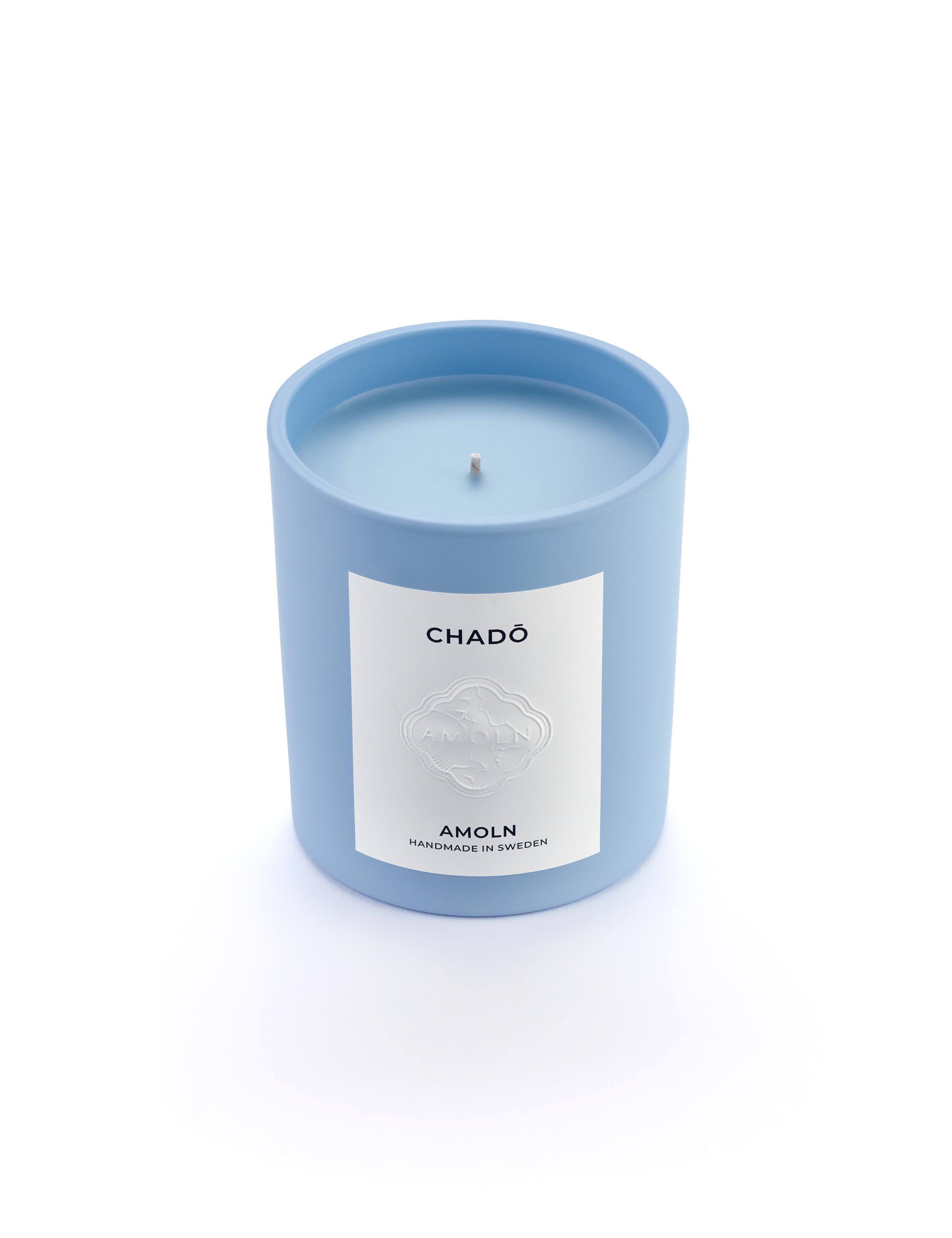 Signature blue candle in the same sky blue ceramic jar, inspired by Scandinavian skies, in the scent Chado - a blend of citrus,  flowers, tea & exotic woods  from Amoln, makers of Sweden's royal candles.