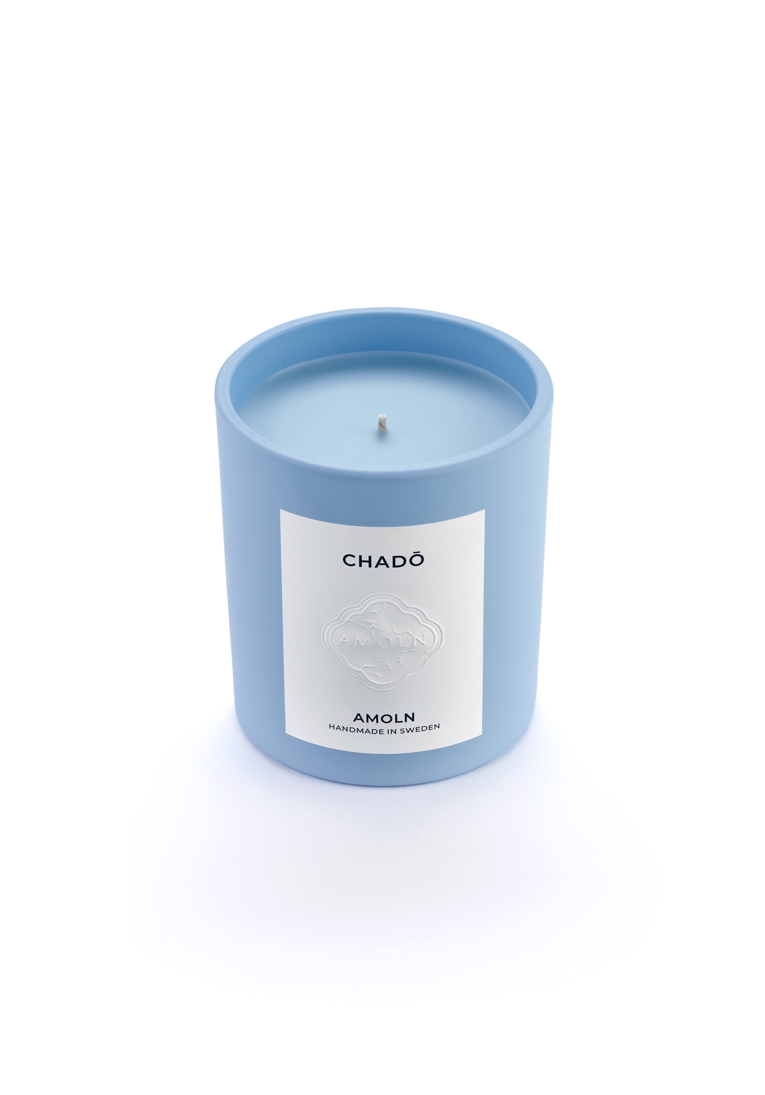 Signature blue candle in the same sky blue ceramic jar, inspired by Scandinavian skies, in the scent Chado - a blend of citrus,  flowers, tea & exotic woods  from Amoln, makers of Sweden's royal candles.