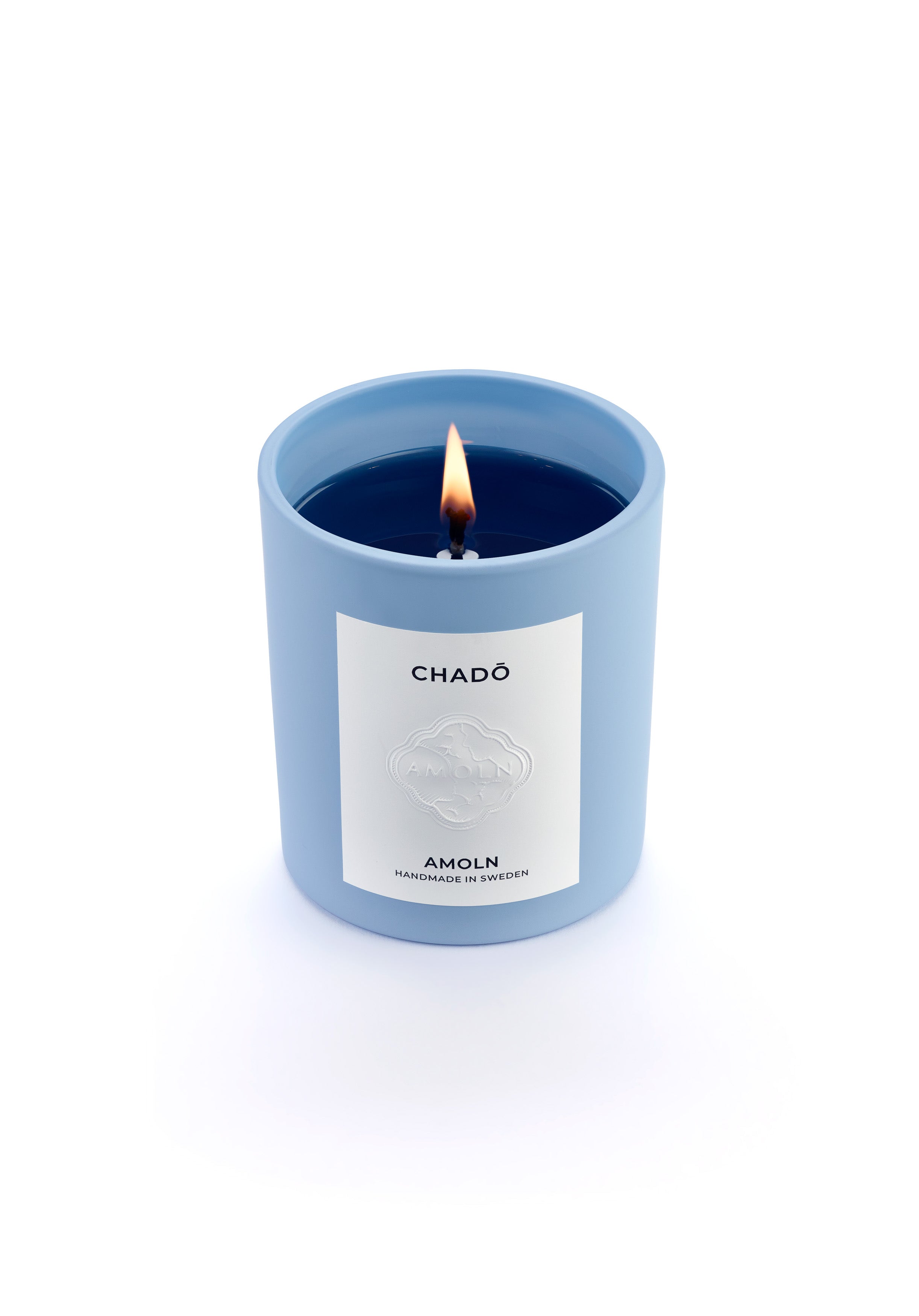 Signature blue candle in the same sky blue ceramic jar, inspired by Scandinavian skies, in the scent Chado - a blend of citrus, flowers, tea & exotic woods from Amoln, makers of Sweden's royal candles.