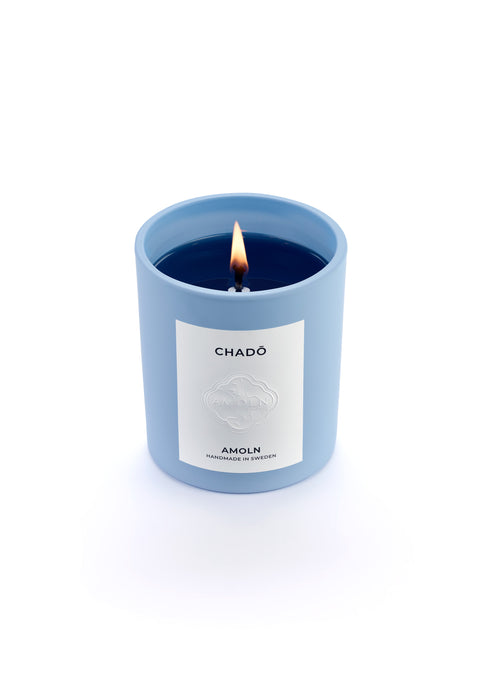 Signature blue candle in the same sky blue ceramic jar, inspired by Scandinavian skies, in the scent Chado - a blend of citrus, flowers, tea & exotic woods from Amoln, makers of Sweden's royal candles.
