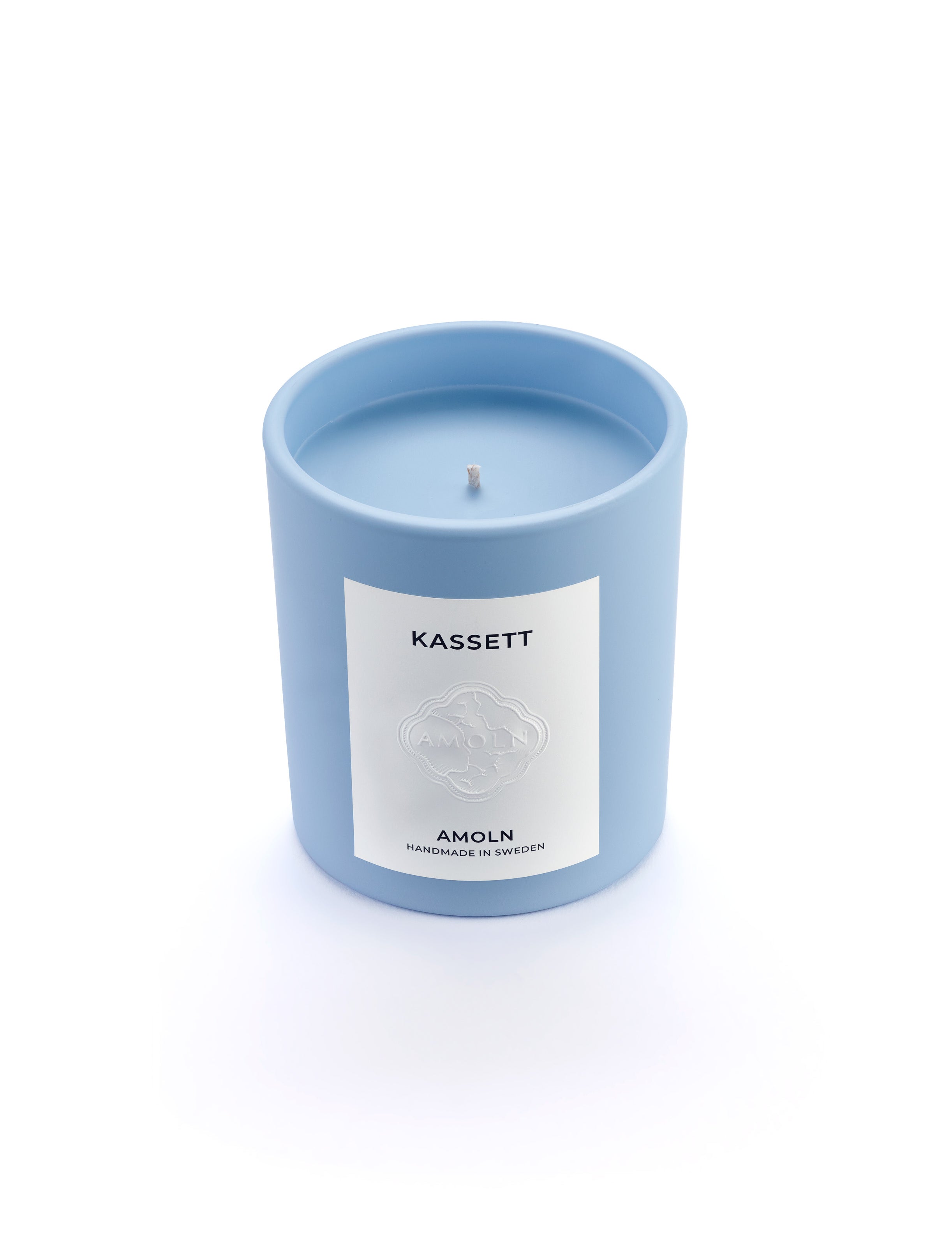 Signature blue candle in the same sky blue ceramic jar, inspired by Scandinavian skies, in the scent Kassett - a blend of fruits, foliage & flowers from Amoln, makers of Sweden's royal candles.