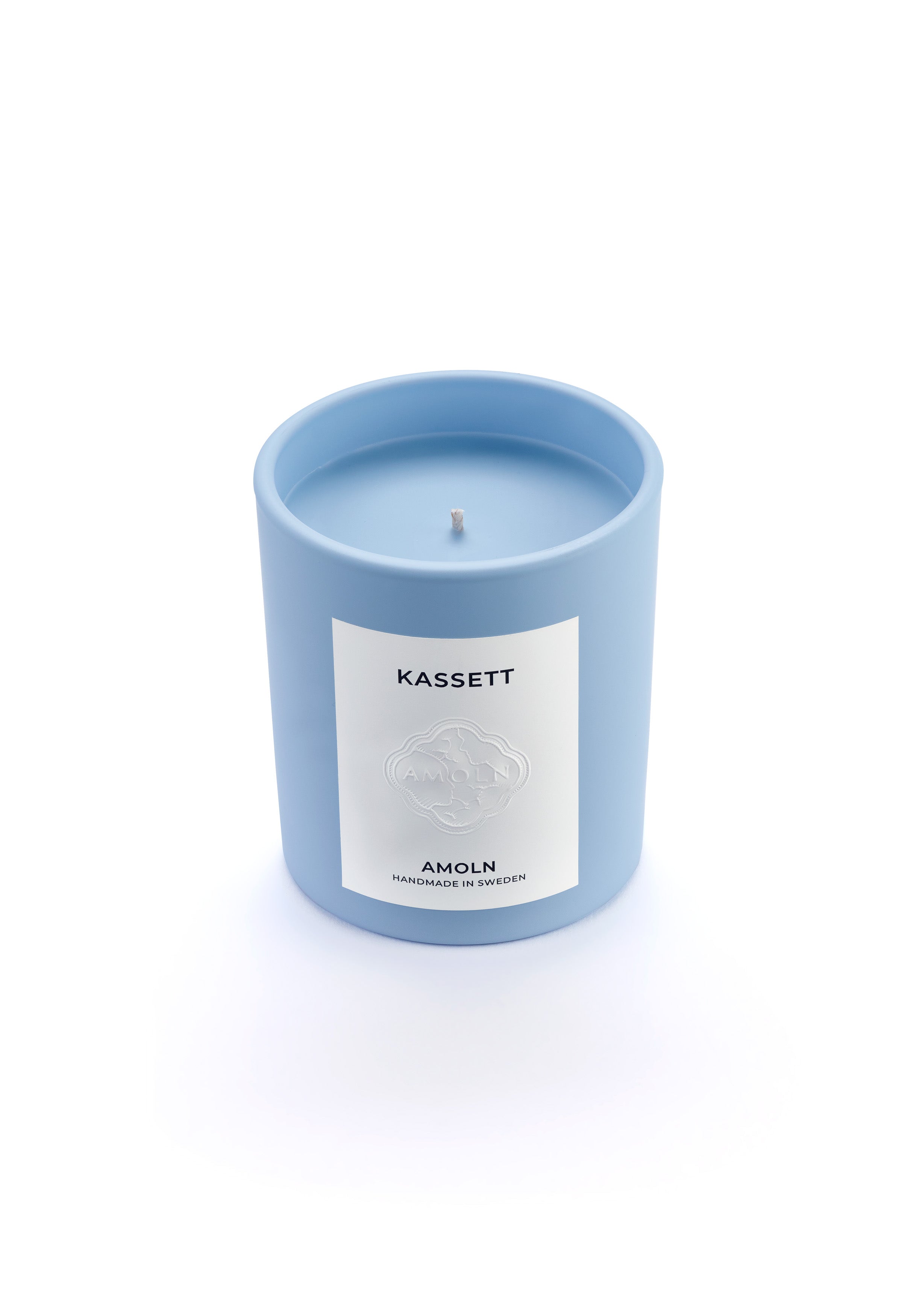 Signature blue candle in the same sky blue ceramic jar, inspired by Scandinavian skies, in the scent Kassett - a blend of fruits, foliage &amp; flowers from Amoln, makers of Sweden&#39;s royal candles.