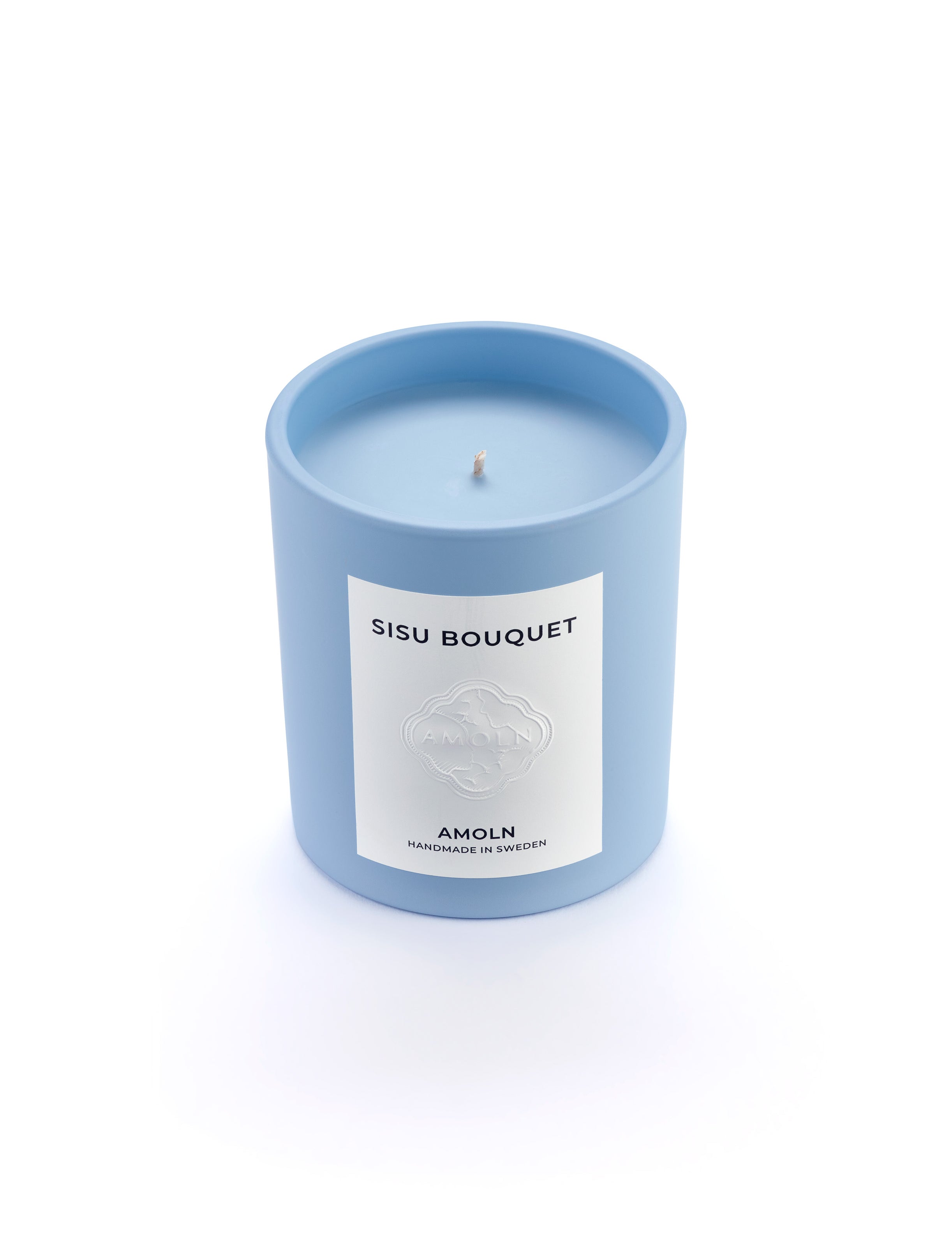 Signature blue candle in the same sky blue ceramic jar, inspired by Scandinavian skies, in the scent Sisu Bouquet - a blend of florals,  saffron, cut grass & woods & violet from Amoln, makers of Sweden's royal candles.