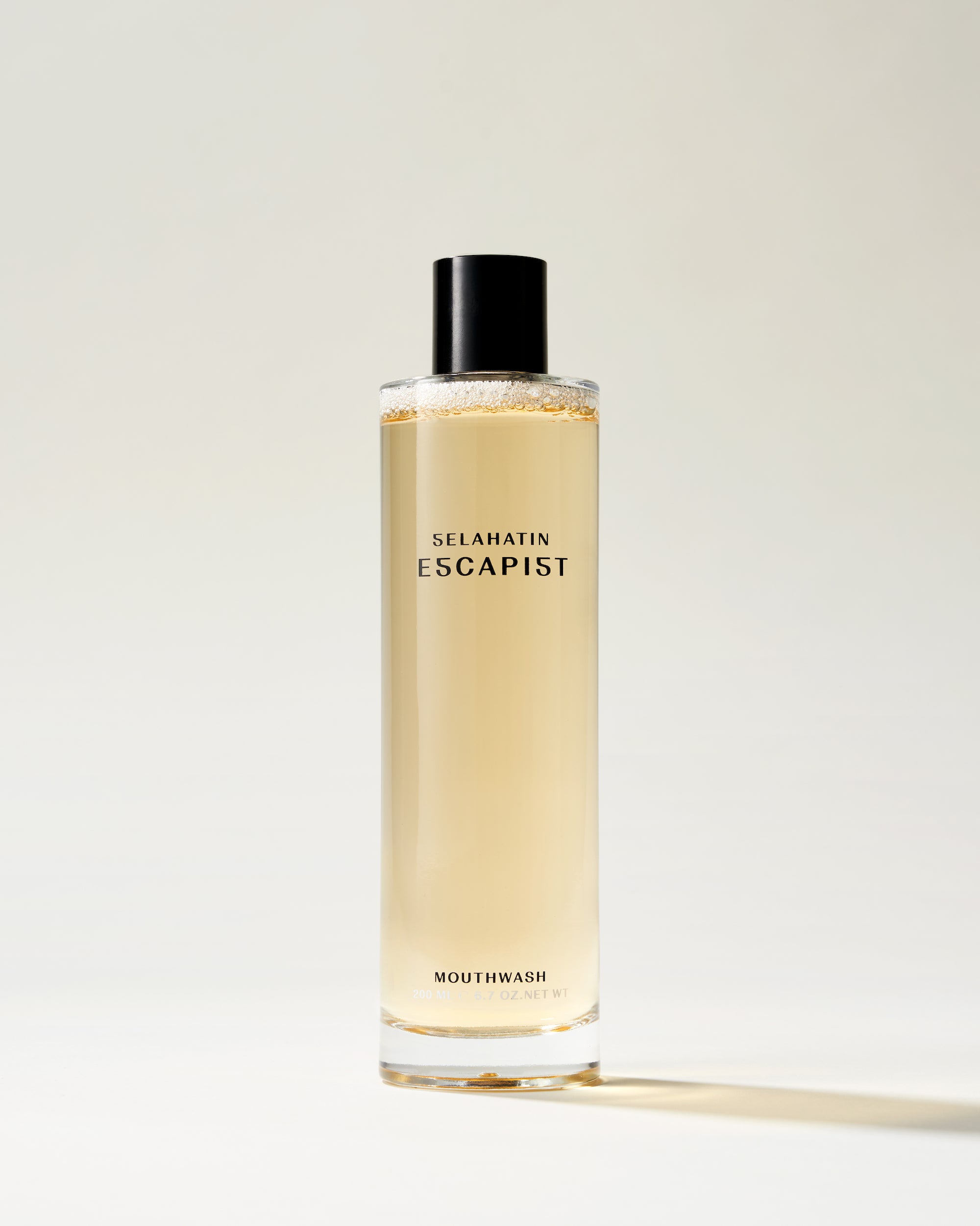 Escapist from Selahatin, vegan, natural luxury mouthwash in stylish glass bottle &amp; white gift packaging . Gift giving for someone who has everything &amp; the design conscious bathroom.