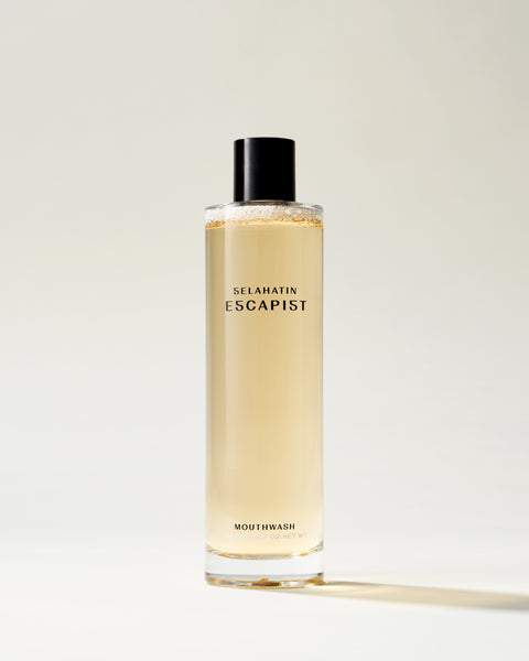 Escapist from Selahatin, vegan, natural luxury mouthwash in stylish glass bottle & white gift packaging . Gift giving for someone who has everything & the design conscious bathroom.