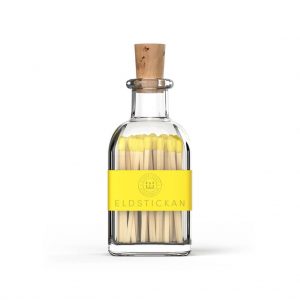 Yellow coloured matches in a stylish glass bottle from Eldstickan for a great interior design idea
