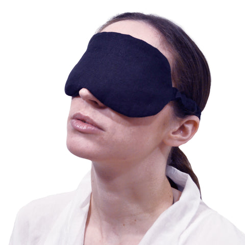Black linen sleep mask with pockets containing organic lavender flowers or chamomile flowers for aromatherapy benefits. Soopz Paris