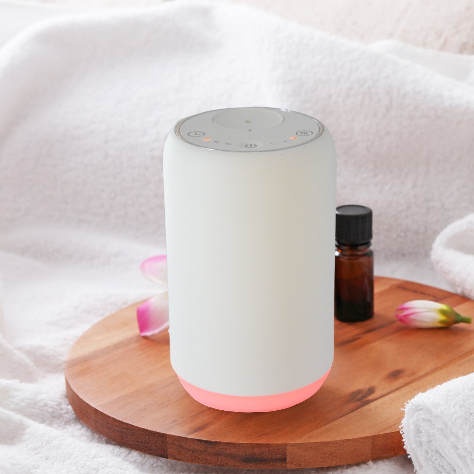 Modern white portable essential oil diffuser, ideal to use in the car, at your desk or anywhere without the need for a cable or wall outlet. No water - simply screw in the essential oil 10ml bottle. Model with coloured light option.