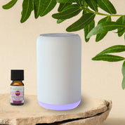 Modern white portable essential oil diffuser, ideal to use in the car, at your desk or anywhere without the need for a cable or wall outlet. No water - simply screw in the essential oil 10ml bottle. Model with coloured light option.