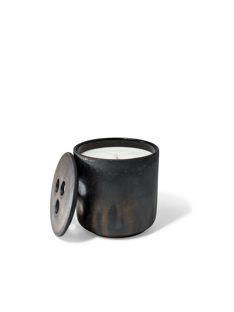 Elegant design and natural sophisticated scent of black wood in this refillable ceramic candle in unique textured finish from Quod Stockholm, with distinctive 3 hole ceramic lid